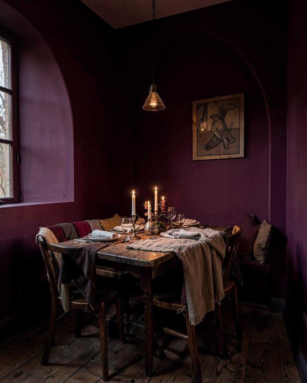 Dining nook painted in Shadowed Plum, lit by candlelight